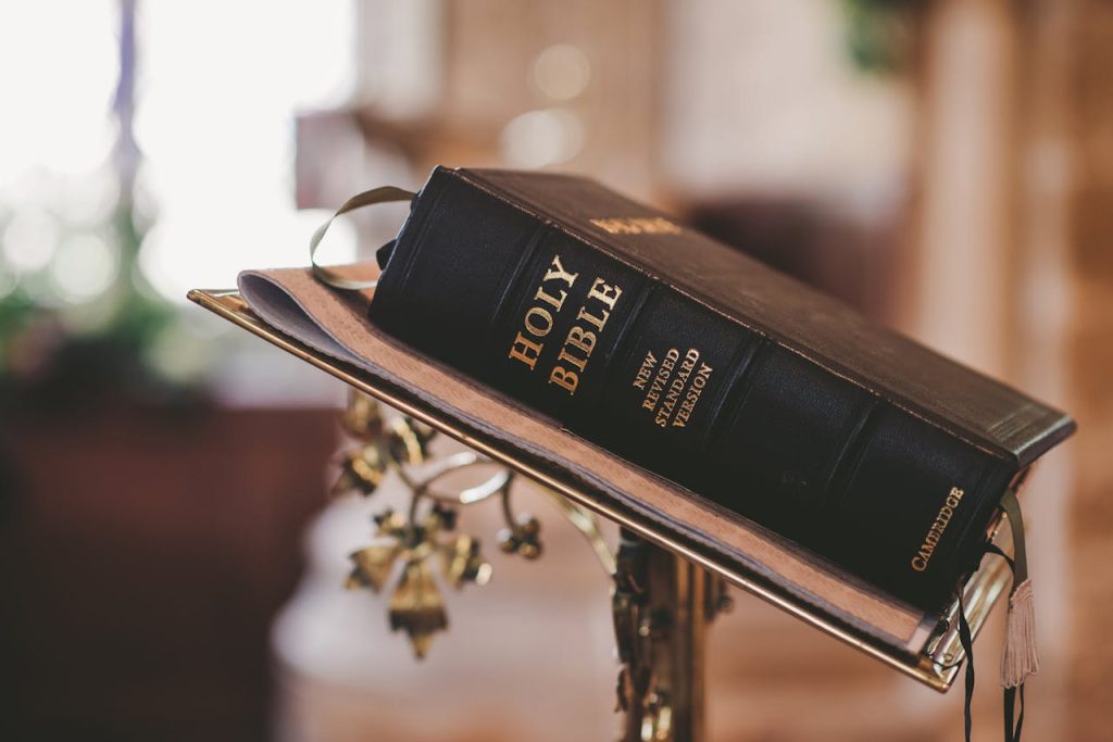holy-bible-on-stand-372326 Holy Bible open on a stand inside a church, symbolizing faith and spirituality.
